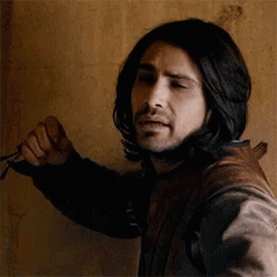 Man With Long Black Hair And Beard Holding Scissors GIF