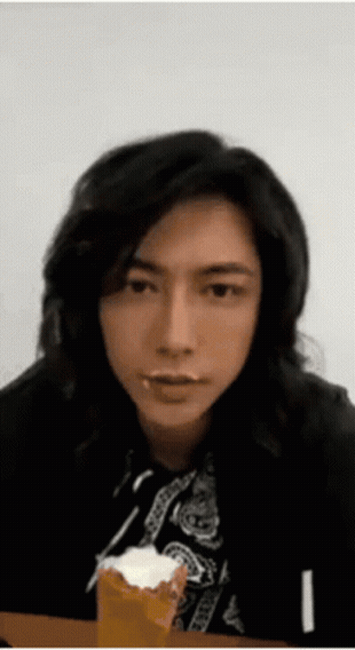 Man With Long Black Hair Eating Cake GIF