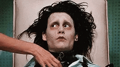 Man With Long Black Hair Lying On Bed With Woman's Hand On Chest GIF