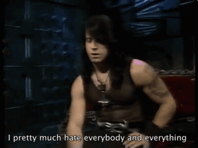 Man With Long Black Hair Sitting On Red Couch Says I Pretty Much Hate Everybody And Everything GIF
