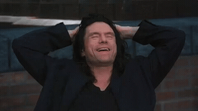 Man With Long Black Hair Smiling Hands To Head GIF