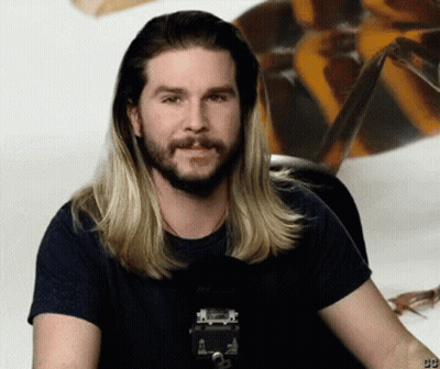 Man With Long Blonde Hair And Beard In Black Shirt With Number 99 GIF
