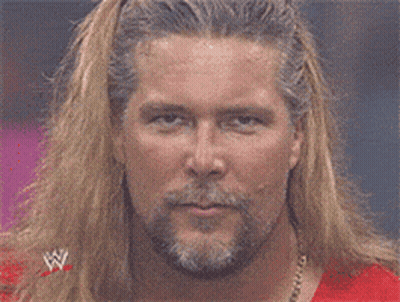 Man With Long Blonde Hair And Beard In Red Wrestling Shirt GIF