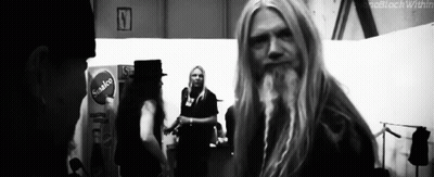 Man With Long Blonde Hair And Beard Standing In Room GIF