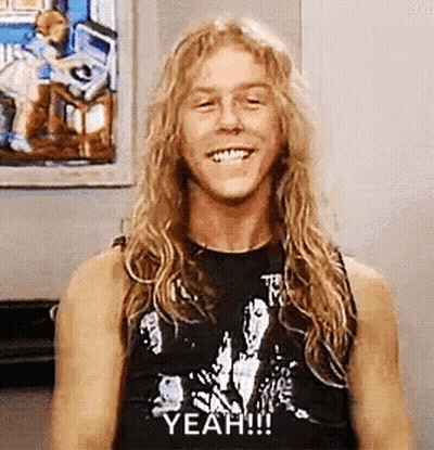 Man With Long Blonde Hair And Black Tank Top Smiling GIF
