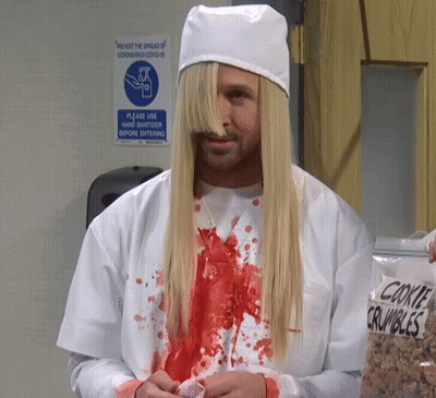 Man With Long Blonde Hair In Front Of Prevent Spread Of Coronavirus Covid 19 Sign GIF