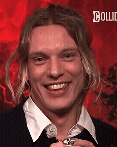 Man With Long Blonde Hair Smiling On Red Background Saying Collid GIF