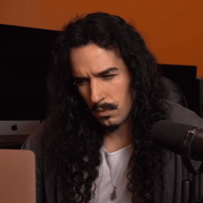 Man With Long Curly Hair And Beard Looking At Laptop GIF