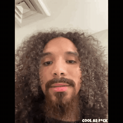 Man With Long Curly Hair And Beard Making Funny Face GIF