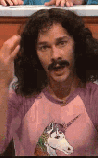 Man With Long Curly Hair And Mustache In Pink Unicorn Shirt GIF