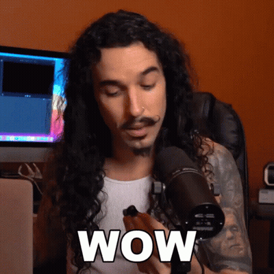 Man With Long Curly Hair Holding Microphone Saying Wow GIF