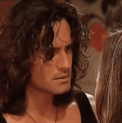 Man With Long Curly Hair Kissing Woman GIF