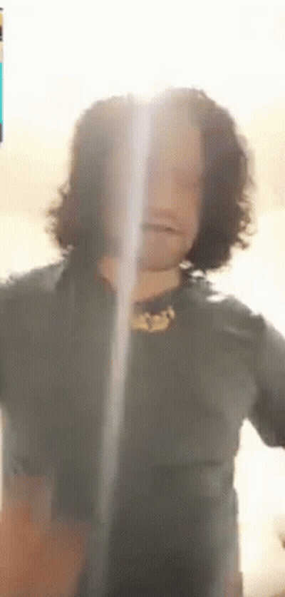 Man With Long Curly Hair Looking At Camera GIF