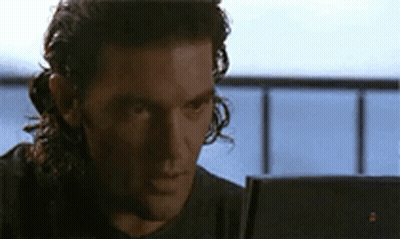 Man With Long Curly Hair Looking At Laptop Computer GIF