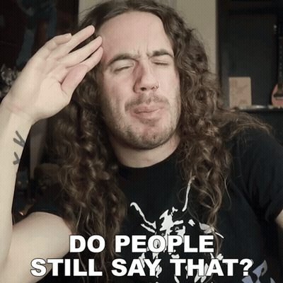 Man With Long Curly Hair Making Funny Face Saying Do People Still Say That GIF