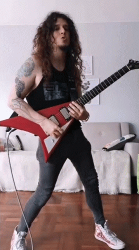 Man With Long Curly Hair Playing Guitar GIF