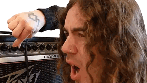 Man With Long Curly Hair Pointing At Band Amplifier Sticker