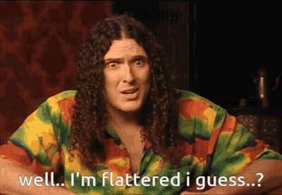 Man With Long Curly Hair Saying Well I'm Flattered GIF