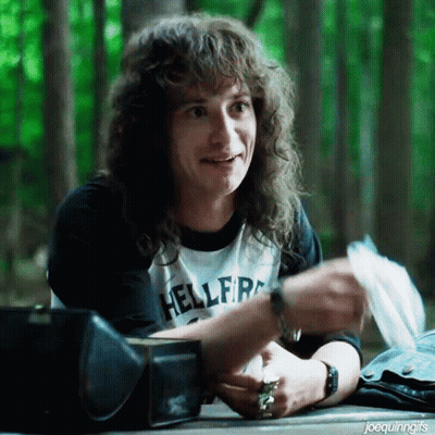 Man With Long Curly Hair Wearing Hellfire Shirt GIF