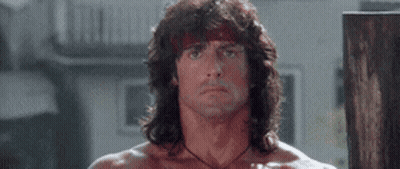 Man With Long Hair And Bandana Standing In Room GIF