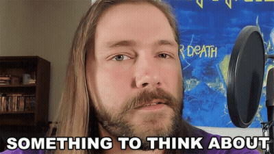 Man With Long Hair and Beard at Microphone