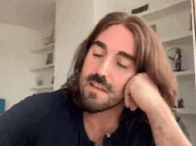 Man With Long Hair And Beard Hand On Chin GIF