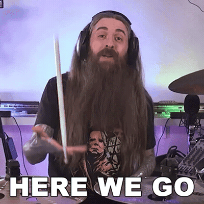 Man With Long Hair And Beard Holding Drum Stick Saying Here We Go GIF