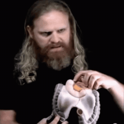 Man With Long Hair And Beard Holding Stuffed Animal GIF