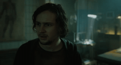 Man With Long Hair And Beard In Dark Room GIF