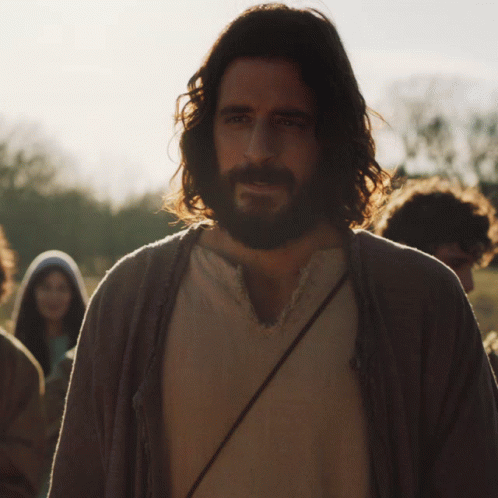 Man With Long Hair And Beard In Front Of Group GIF