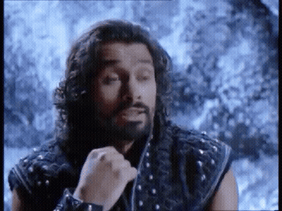 Man With Long Hair And Beard In Front Of Snowy Mountain GIF