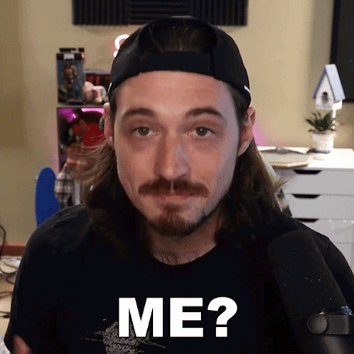 Man With Long Hair And Beard In Hat And Black Shirt Saying Me GIF