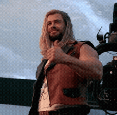 Man With Long Hair And Beard In Red Leather Vest GIF
