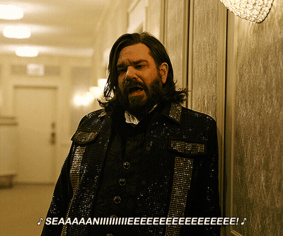 Man With Long Hair And Beard In Sequined Jacket GIF