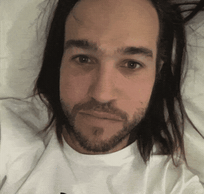 Man With Long Hair And Beard Laying Down GIF