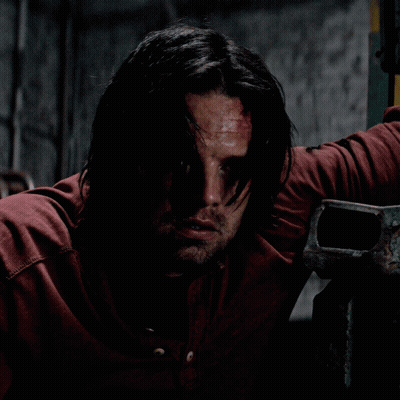 Man With Long Hair And Beard Leaning Against Wall GIF