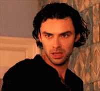 Man With Long Hair And Beard Looking At Camera GIF