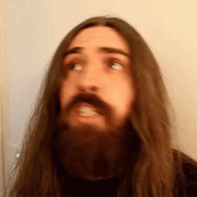 Man With Long Hair And Beard Making Face GIF