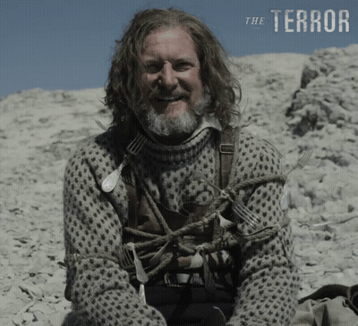Man With Long Hair And Beard On Rocky Hill Saying Terror GIF
