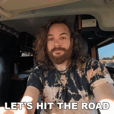 Man With Long Hair And Beard Says Let's Hit The Road In Car GIF