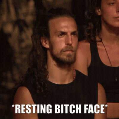 Man With Long Hair And Beard Sitting Next To Woman Saying Resting Bitch Face GIF