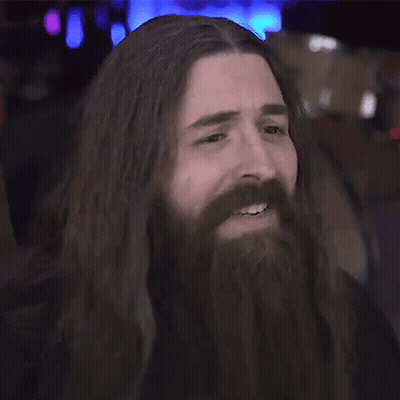 Man With Long Hair And Beard Smiles GIF