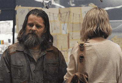 Man With Long Hair And Beard Stands Next To Woman GIF