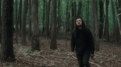 Man With Long Hair And Beard Walking Through Forest GIF