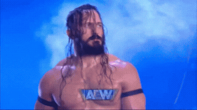 Man With Long Hair And Beard Wearing AEW Shirt GIF