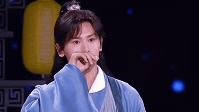 Man With Long Hair And Blue Robe Covering Mouth GIF