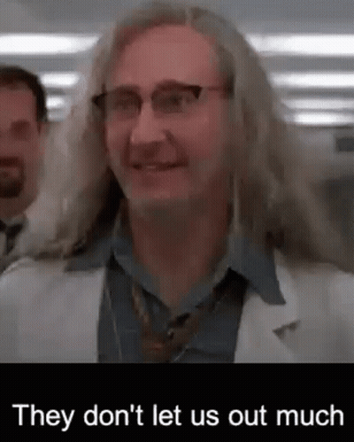 Man With Long Hair And Glasses In Lab Coat And Tie GIF