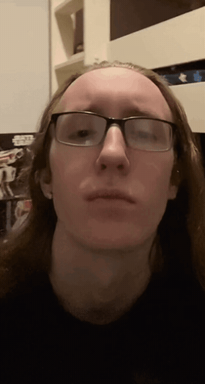 Man With Long Hair And Glasses Making Funny Face GIF