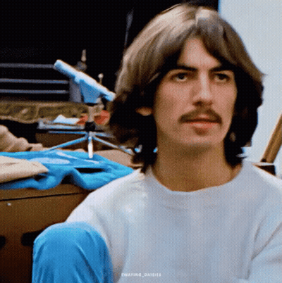 Man With Long Hair And Mustache In White T-Shirt GIF