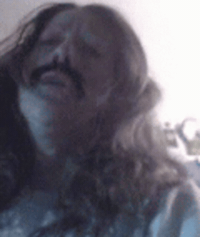 Man With Long Hair And Mustache Making Funny Face GIF